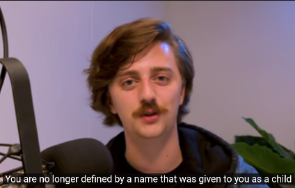 Brian David Gilbert, a white man with shaggy brown hair and a mustache says You are no longer defined by a name that was given to you as a child